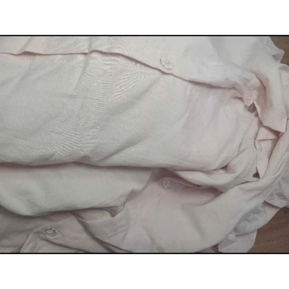 Light pink twin duvet cover with pillow sham. Ruffled edges and button close